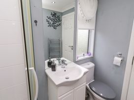 A bathroom with a sink and toilet at Harper's Hideaway near Felmoor Holiday Park near Felton