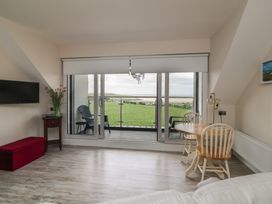 A living room with a television and dining table at Ard Uisce @ Estuary Bliss Duncannon, County Wexford