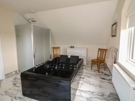 A bathroom with a black bathtub and shower at Ard Uisce @ Estuary Bliss, Duncannon, County Wexford