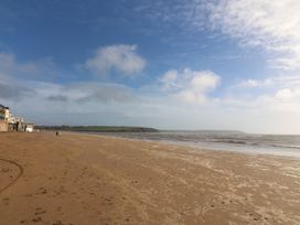 A beach with sand and ocean waves at Ard Uisce @ Estuary Bliss in Duncannon, County Wexford