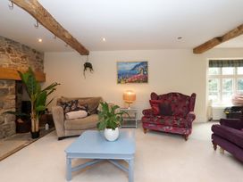 A living room with a sofa and armchairs at The Mill House in Newton Abbot