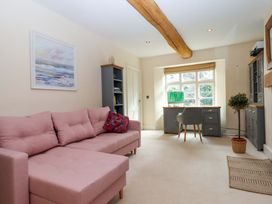 A snug with a sofa and desk at The Mill House in Newton Abbot