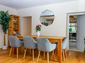 A dining room with a table and chairs at The Mill House in Newton Abbot