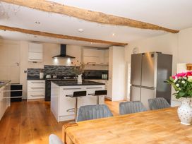 A kitchen with cabinets and an island at The Mill House in Newton Abbot