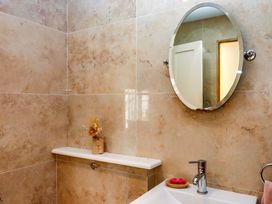 A bathroom with a sink and mirror at The Mill House in Newton Abbot