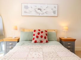 A bedroom with a bed and bedside tables at The Mill House in Newton Abbot