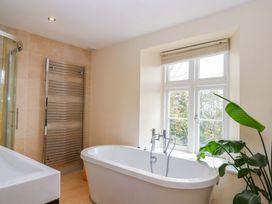 A bathroom with a bathtub and shower at The Mill House in Newton Abbot