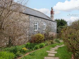 A garden with pathway and stone wall at The Mill House in Newton Abbot