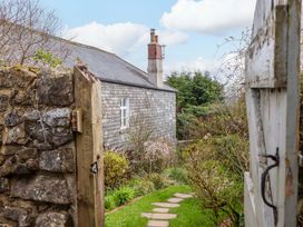 A garden with flowers and a pathway at The Mill House in Newton Abbot