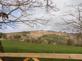 A view of a hillside with trees and clouds at The Mill House in Newton Abbot