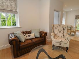 A living room with a sofa and an armchair at The Lodge House in Dolphinholme near Galgate