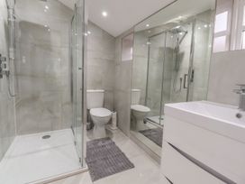 A bathroom with a shower, toilet, and sink at The Lodge House in Dolphinholme near Galgate