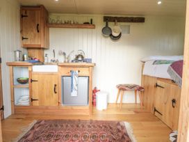 A kitchen with storage and appliances at Honeysuckle Hut, Potto Grange Farm, Northallerton