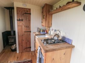 A kitchen with a stove and kettle at Honeysuckle Hut, Potto Grange Farm, Northallerton