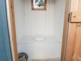 A bathroom with a toilet and a window at Honeysuckle Hut, Potto Grange Farm Northallerton