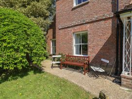 An outdoor area with a bench and chairs at Goulds Farmhouse in Milborne St Andrew
