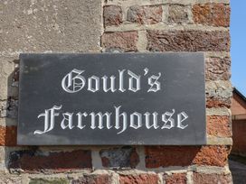 A sign for Gould's Farmhouse on a brick wall at Goulds Farmhouse Milborne St Andrew