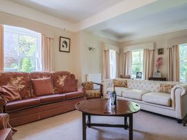 A living room with sofas and a coffee table at Goulds Farmhouse in Milborne St Andrew