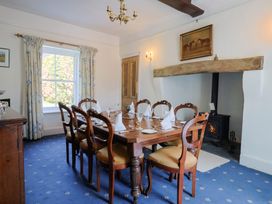 A dining room with a table set for dinner at Goulds Farmhouse in Milborne St Andrew
