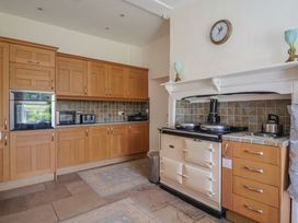A kitchen with cabinets and stove at Goulds Farmhouse in Milborne St Andrew