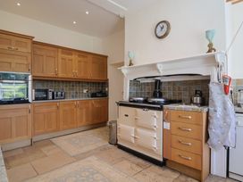 A kitchen with cabinets and an oven at Goulds Farmhouse in Milborne St Andrew