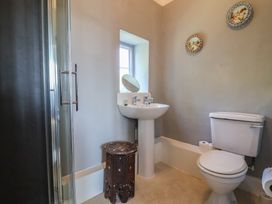 A bathroom with a sink, shower, and toilet at Goulds Farmhouse in Milborne St Andrew