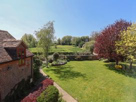 A garden with grass and trees at Goulds Farmhouse in Milborne St Andrew