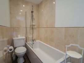 A bathroom with a bathtub and toilet at Goulds Farmhouse in Milborne St Andrew