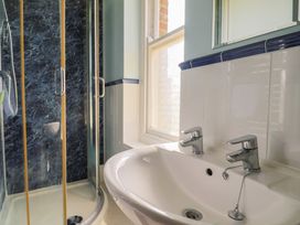 A bathroom with a shower and sink at Goulds Farmhouse in Milborne St Andrew