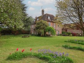 A house with a garden and trees at Goulds Farmhouse Milborne St Andrew