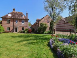 A house with a garden and flowers at Goulds Farmhouse in Milborne St Andrew