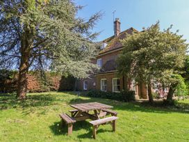 A garden with a table and benches at Goulds Farmhouse in Milborne St Andrew
