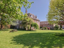 A house with a garden and trees at Goulds Farmhouse in Milborne St Andrew