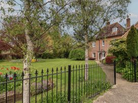 A house with a garden and fence at Goulds Farmhouse in Milborne St Andrew