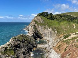 A coastal view with cliffs and ocean at Goulds Farmhouse Milborne St Andrew