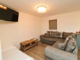 A living room with a sofa and television at Tooth Suite in Yarm
