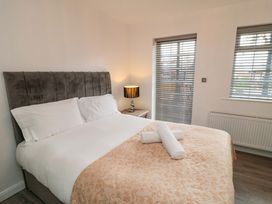 A bedroom with a bed and bedside table at Tooth Suite Yarm
