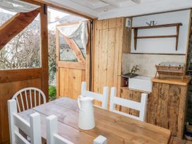 A kitchen with a wooden dining table and sink at Studio Bach Beaumaris