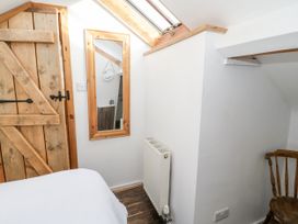 A bedroom with wooden door and mirror at Studio Bach Beaumaris