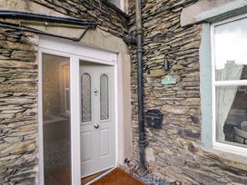 An entrance with a door and stone wall at Flat 5 Caxton House Windermere