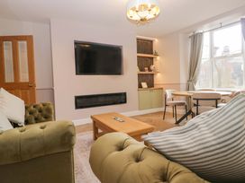 A living room with a sofa and coffee table at Flat 5 Caxton House in Windermere