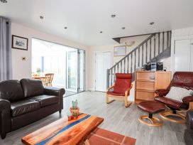 A living room with a sofa and coffee table at Bodlasan Groes Cottage in Holyhead