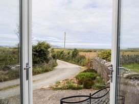 A view of a road and fields from a window at Bodlasan Groes Cottage in Holyhead