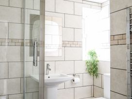 A bathroom with a shower and sink at Bodlasan Groes Cottage in Holyhead