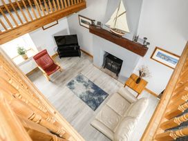 A living room with a sofa and armchair at Bodlasan Groes House in Holyhead