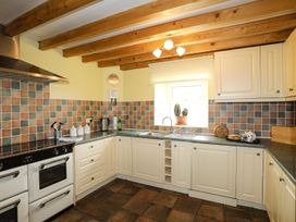A kitchen with a stove and sink at Bodlasan Groes House in Holyhead