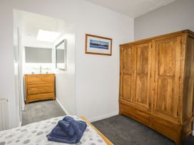 A bedroom with a wardrobe and a drawer at Bodlasan Groes House in Holyhead