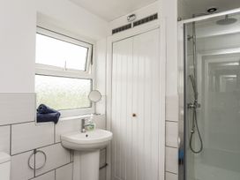 A bathroom with a sink and a shower at Bodlasan Groes House in Holyhead