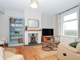 A living room with a fireplace and TV at 4 Polgrain Turning St. Wenn near St Columb Major