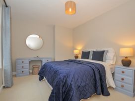 A bedroom with a bed and dressing table at 4 Polgrain Turning St. Wenn near St Columb Major